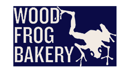 Logo for Wood Frog Bakery featuring white text and a silhouette of a frog on a dark background.