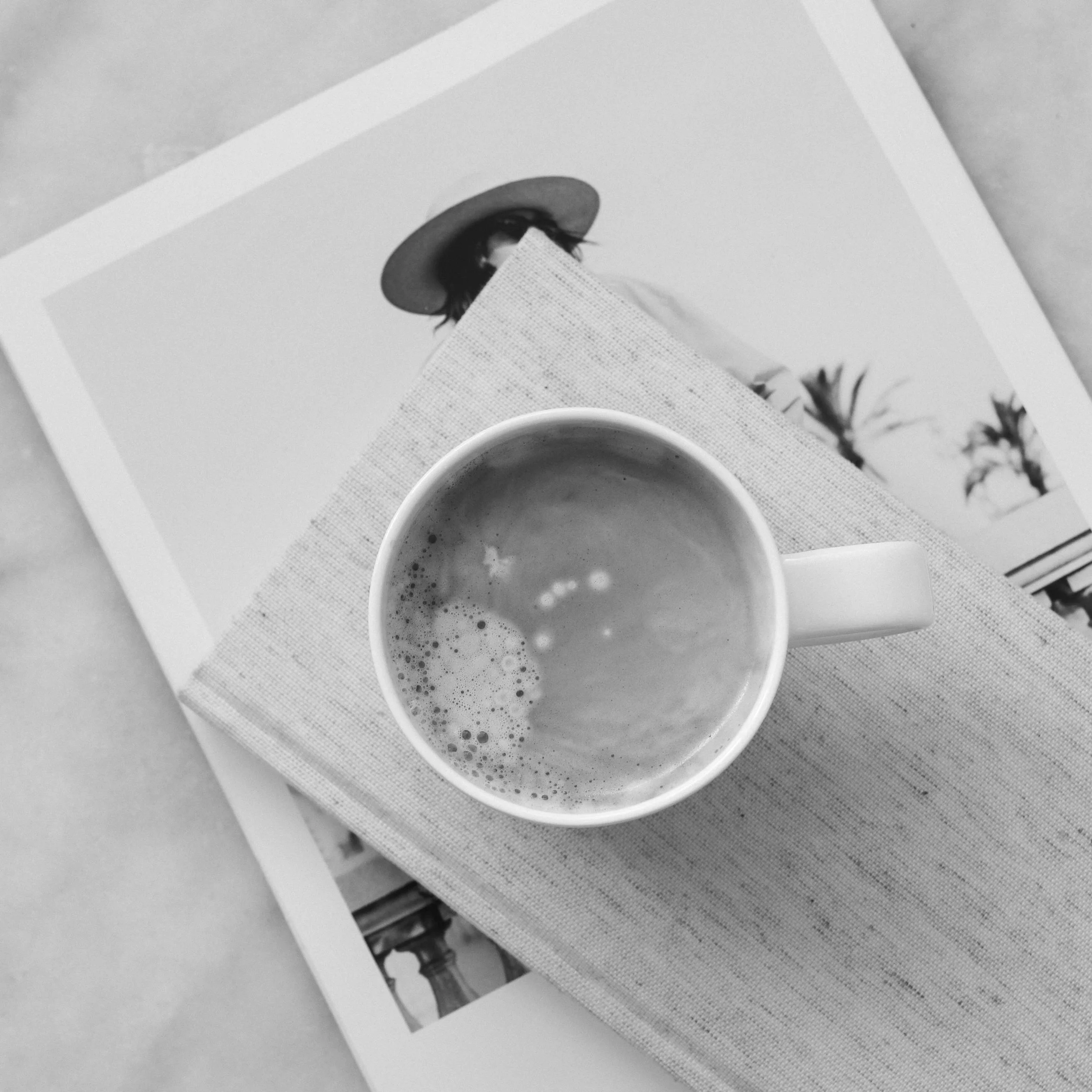 Overhead view of a coffee cup on a timber tray