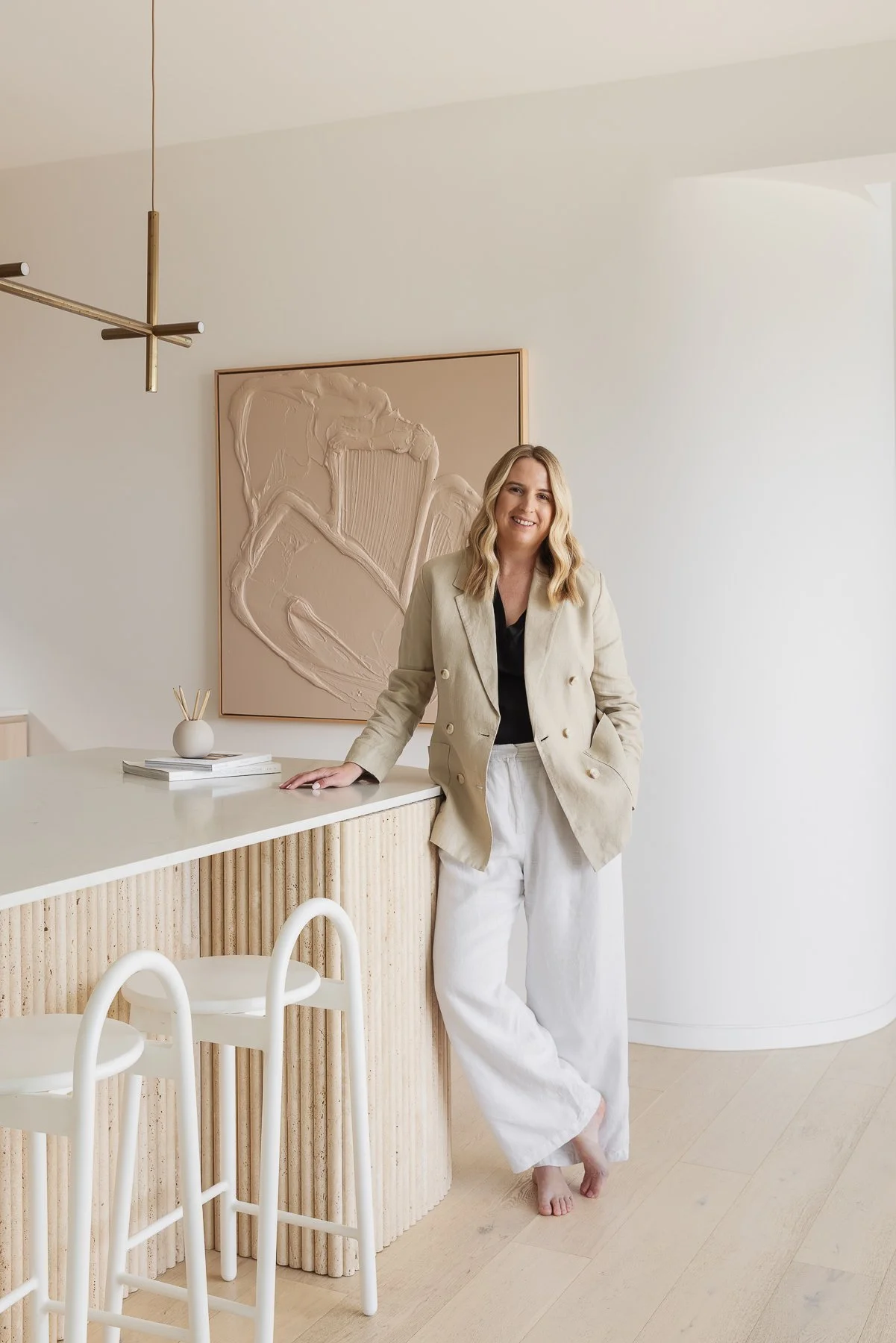 Hayley standing in a modern, light-filled kitchen