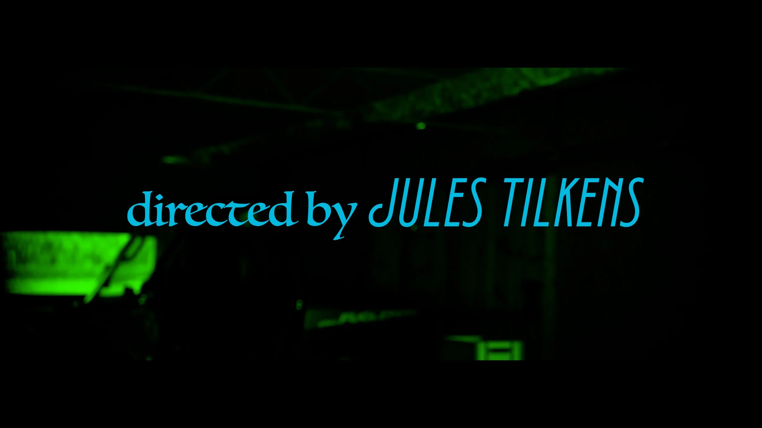 Title screen with the text 'directed by JULES TELLERIS' in blue on a dark background with green lighting effects.