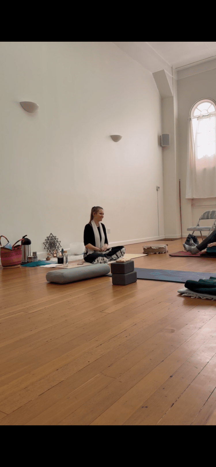 Julia Dyer teaching a small group in a yoga studio