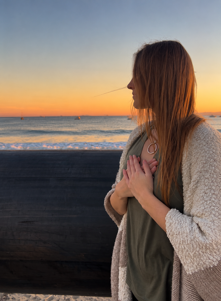 Julia Dyer looking out over the ocean at sunset