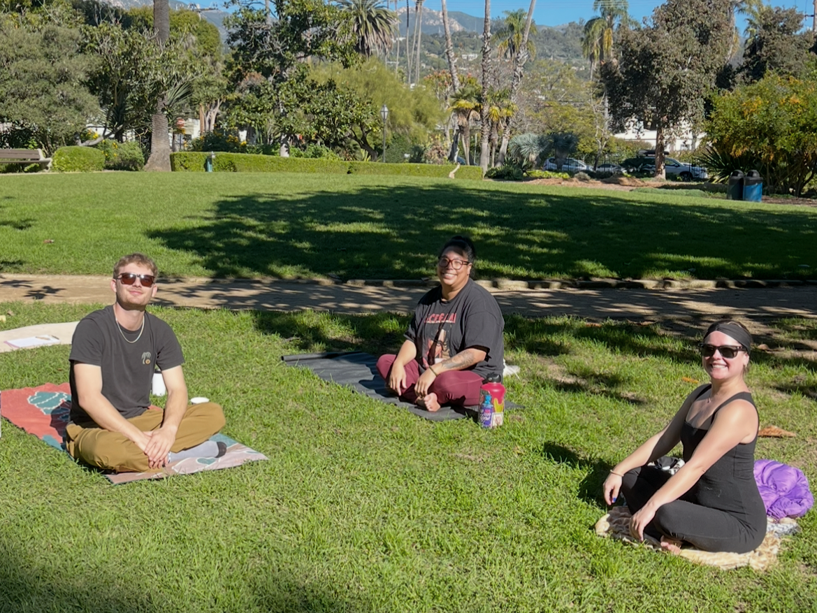 Participants seated on the grass at a free community meditation gathering in Alice Keck Park Memorial Garden in Santa Barbara.