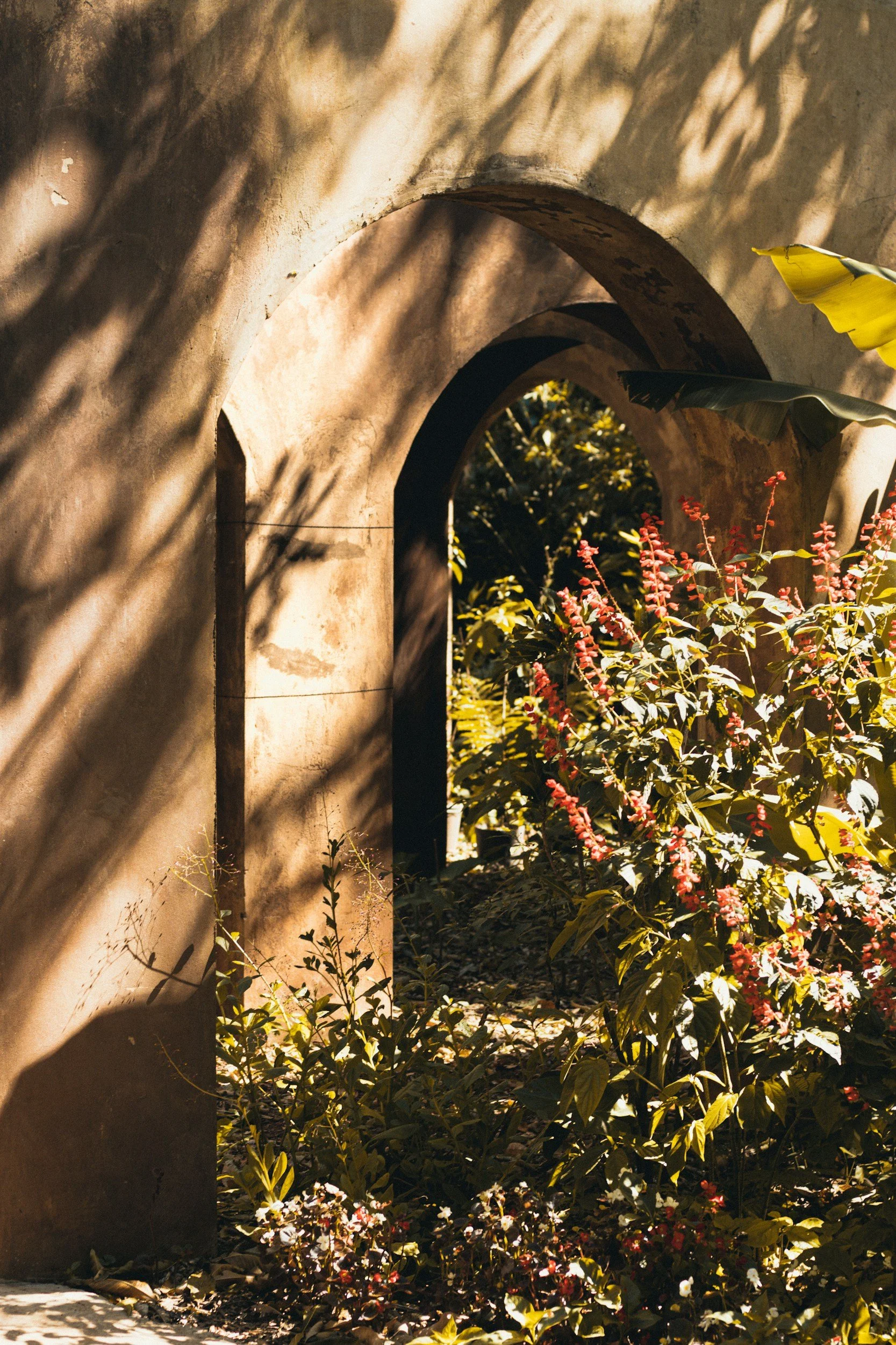 Stone archway leading into a garden.