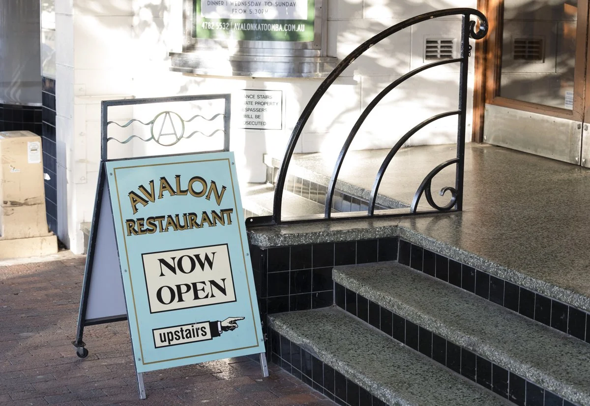 An A-frame open sign outside Avalon Katoomba