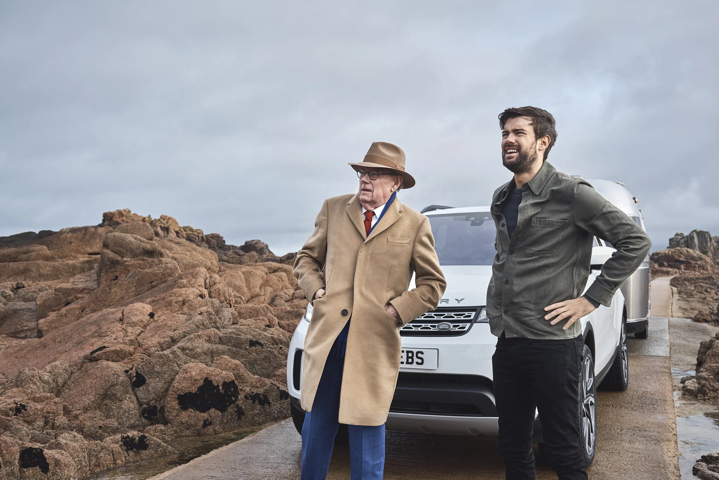 Jack Whitehall and his dad stood in front of a Land Rover Discovery