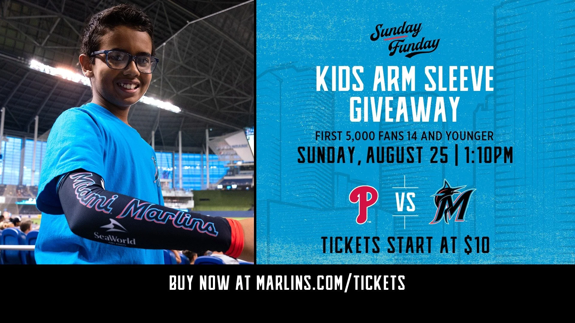 A young boy wearing glasses and a blue Mariners shirt with a Mariners logo and SeaWorld written on his sleeve, smiling inside a baseball stadium. Next to him is a blue promotional graphic with details about a kids arm sleeve giveaway contest for fans