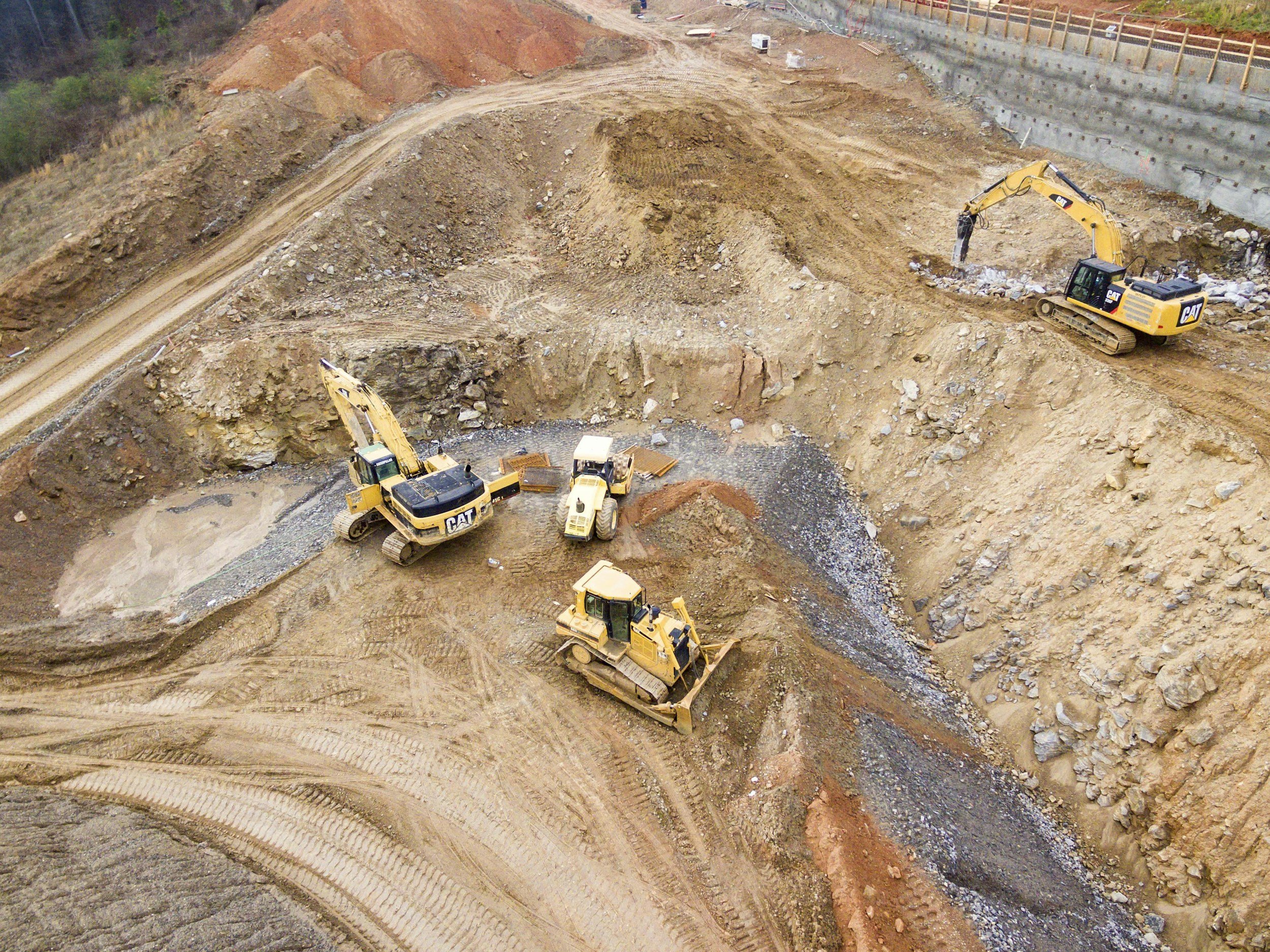 construction jobsite excavation with heavy equipment and earthwork operations like in Kentucky