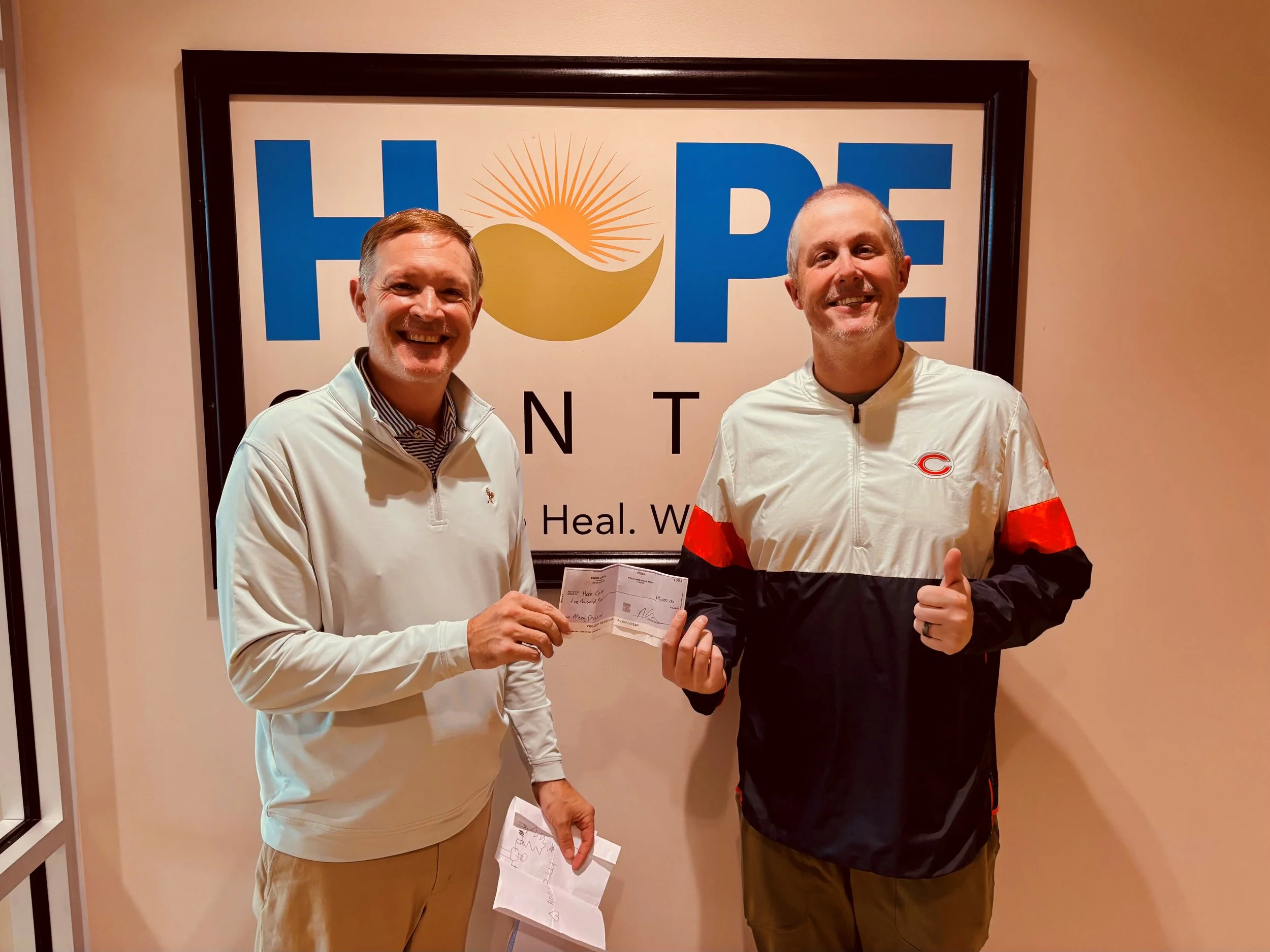 Nathan Simon of Simon Law PLLC presenting $5,000 donation to the Hope Center in Lexington, Kentucky