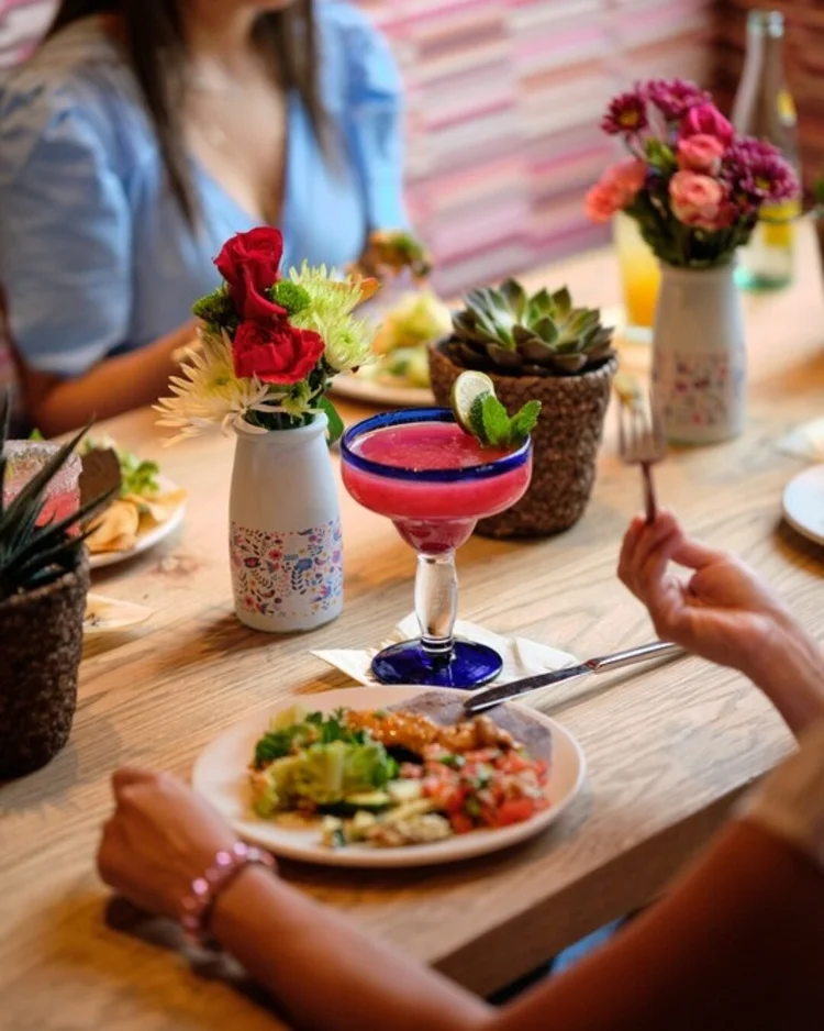 Friends sharing dinner and drinks at Amasa Mexican Kitchen