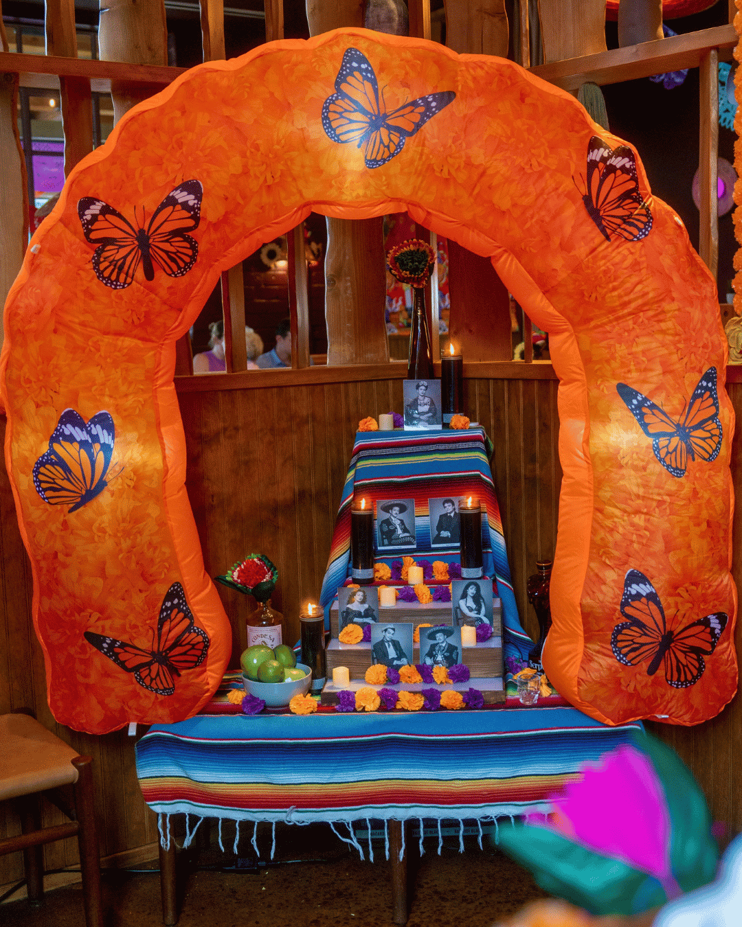 Day of the Dead ofrenda altar with photos and candles at Amasa Mexican Kitchen