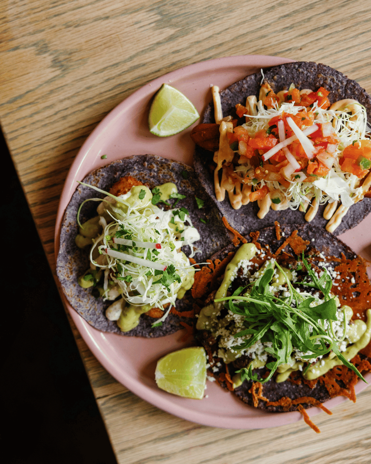 Street tacos on a pink plate at Amasa Mexican Kitchen