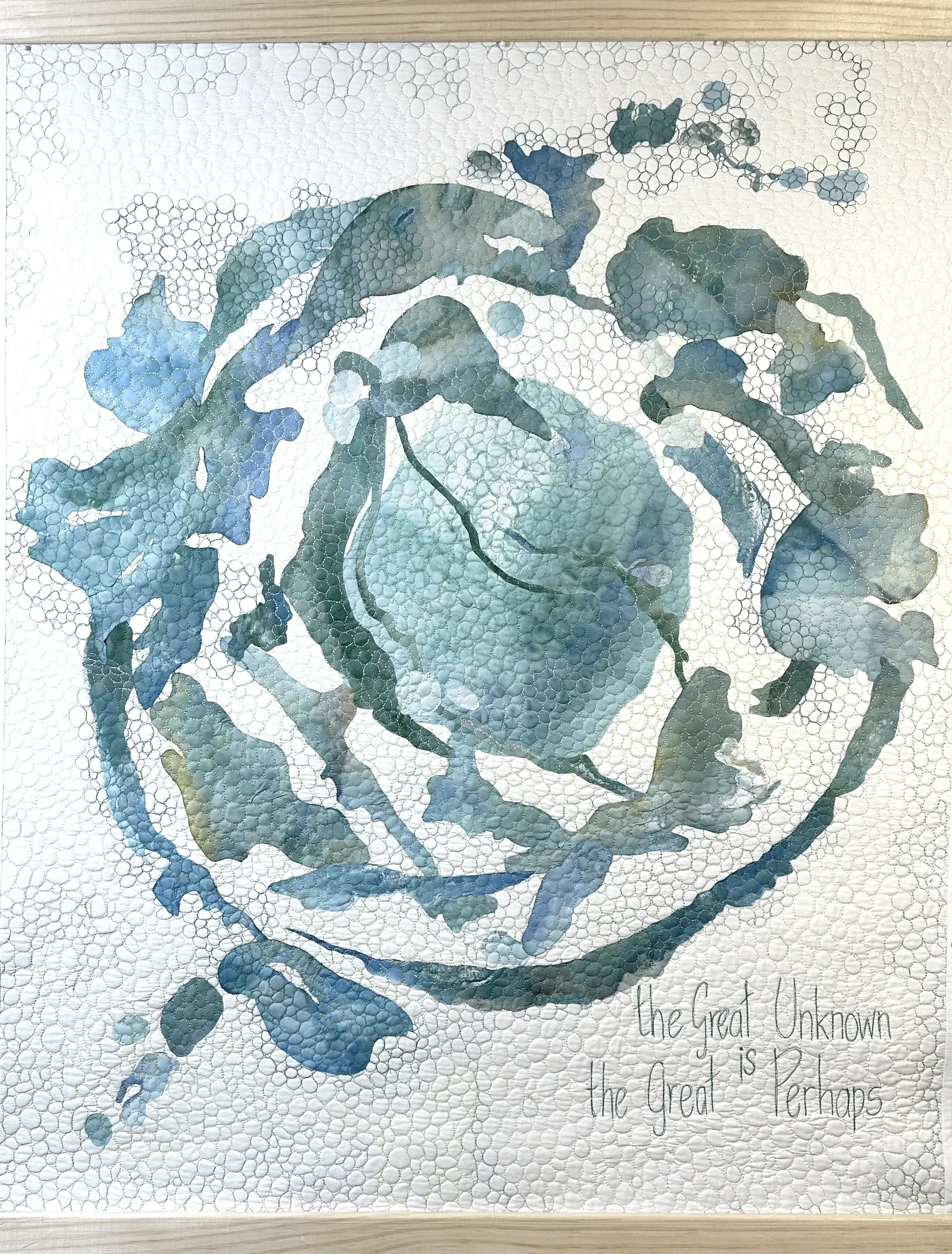A fiber art collage of painted fabrics stitched onto a white background in a swirling world making sort of pattern. Text reads: The Great Unknown is The Great Perhaps.