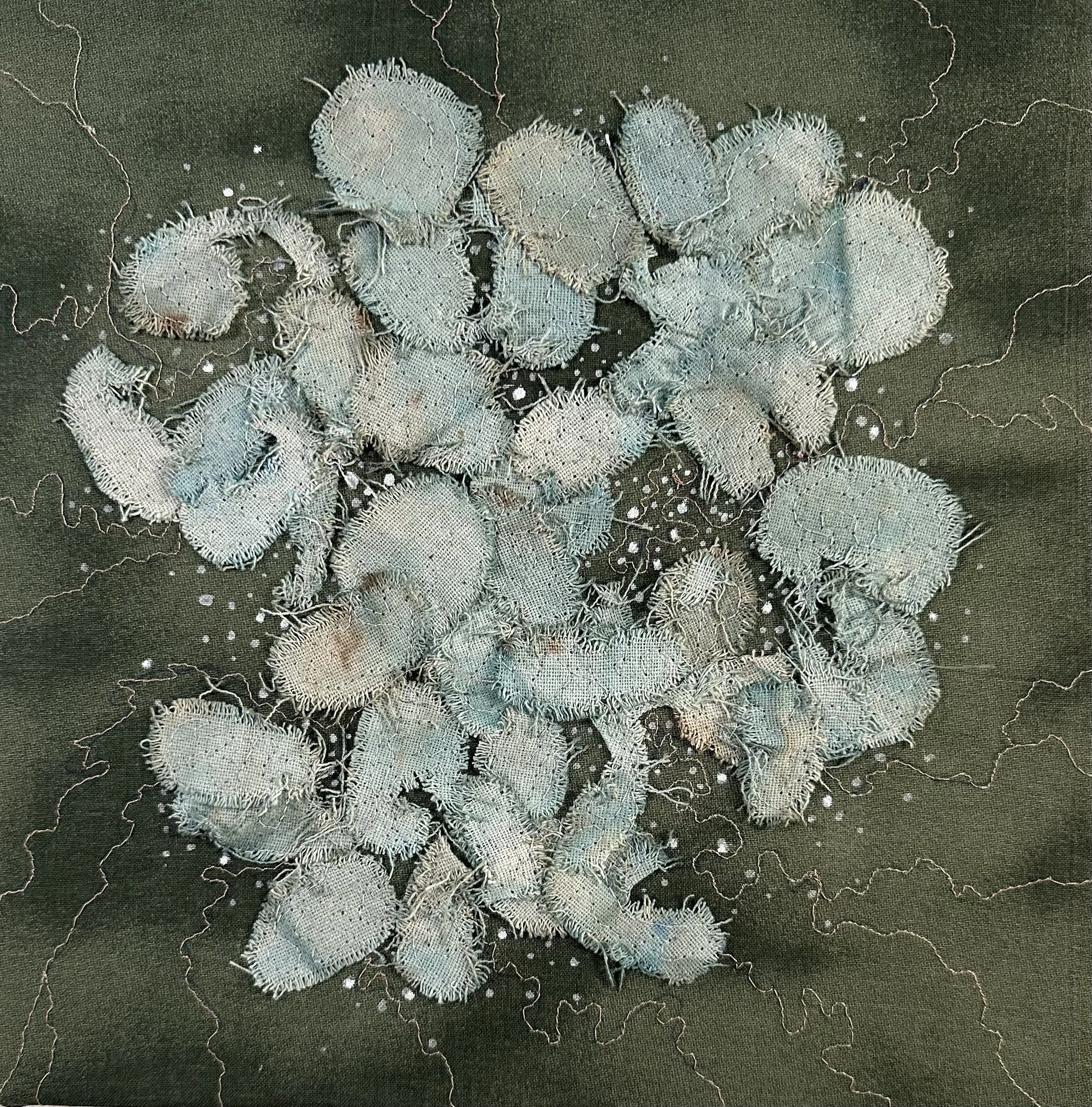 Appliquéd and altered fabric stitched to a dark background with added stitched pathways