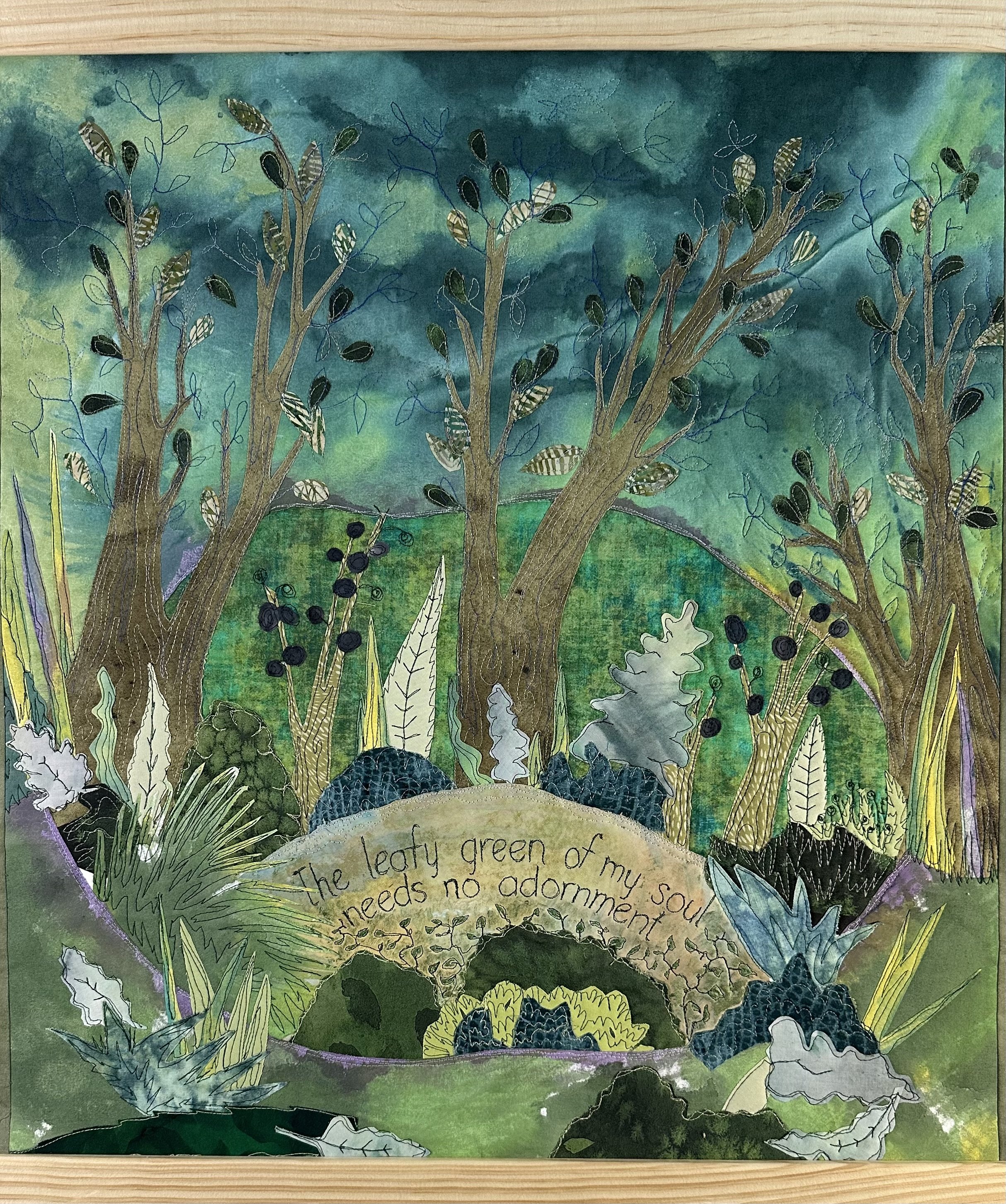 A fiber art collage painting that expresses the sentiment: The leafy green of my soul needs no adornment and is surrounded by many colors of green pants in a landscape.