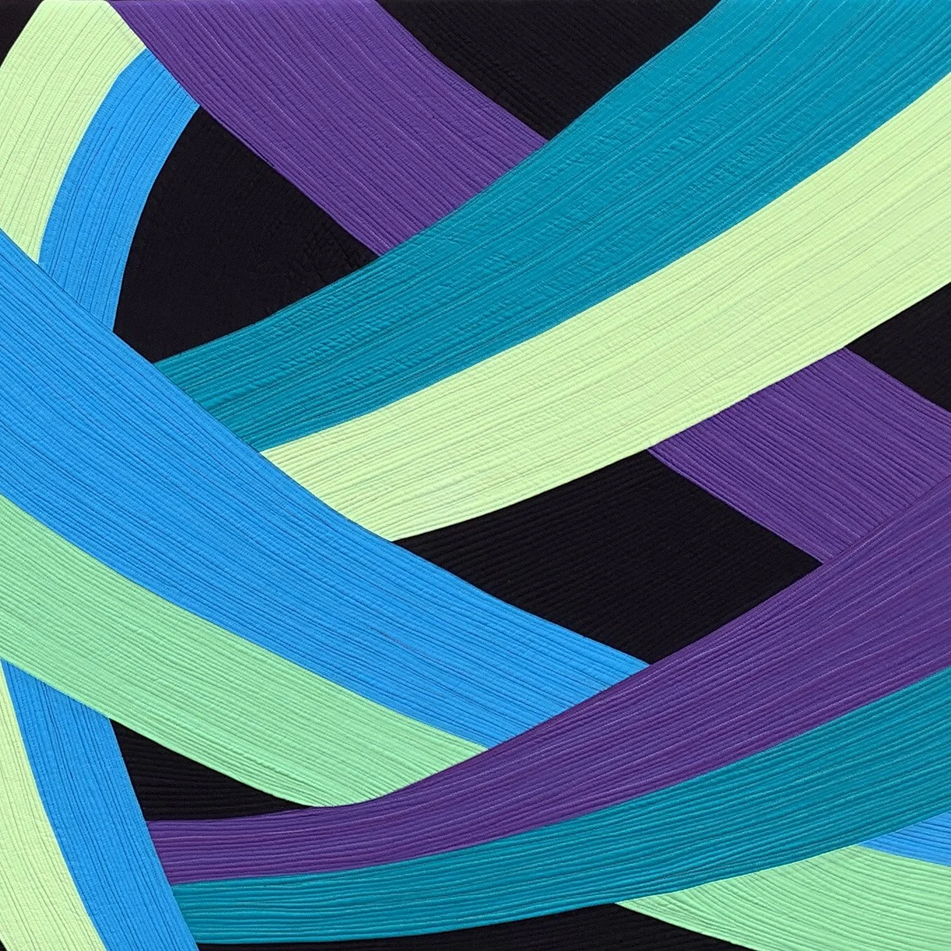 Close-up of colorful fabric woven ribbons in green, blue, purple, and black, overlapping and creating a layered pattern.
