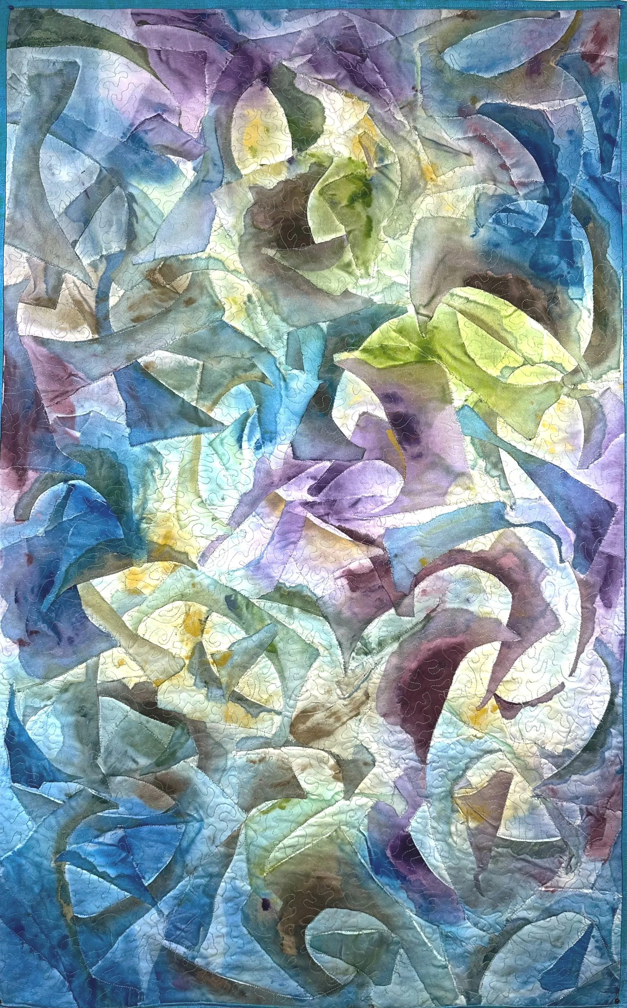 A colorful abstract f painted collaged pieces on a painted fabric background with swirling patterns in shades of blue, green, yellow, purple, and brown.