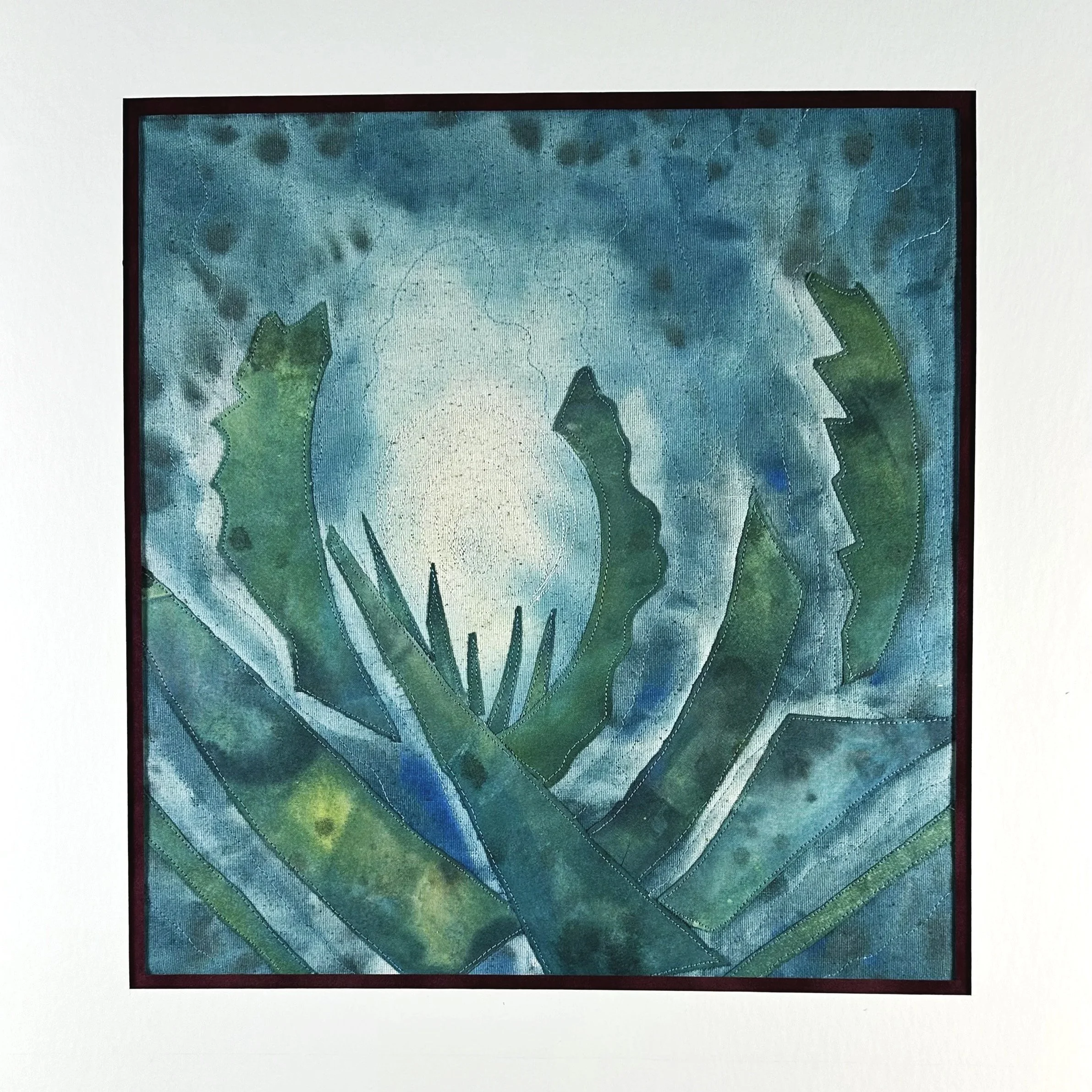 A framed fiber art painting suggesting leafy plants opening , with a blue-green  and light yellow  in the background