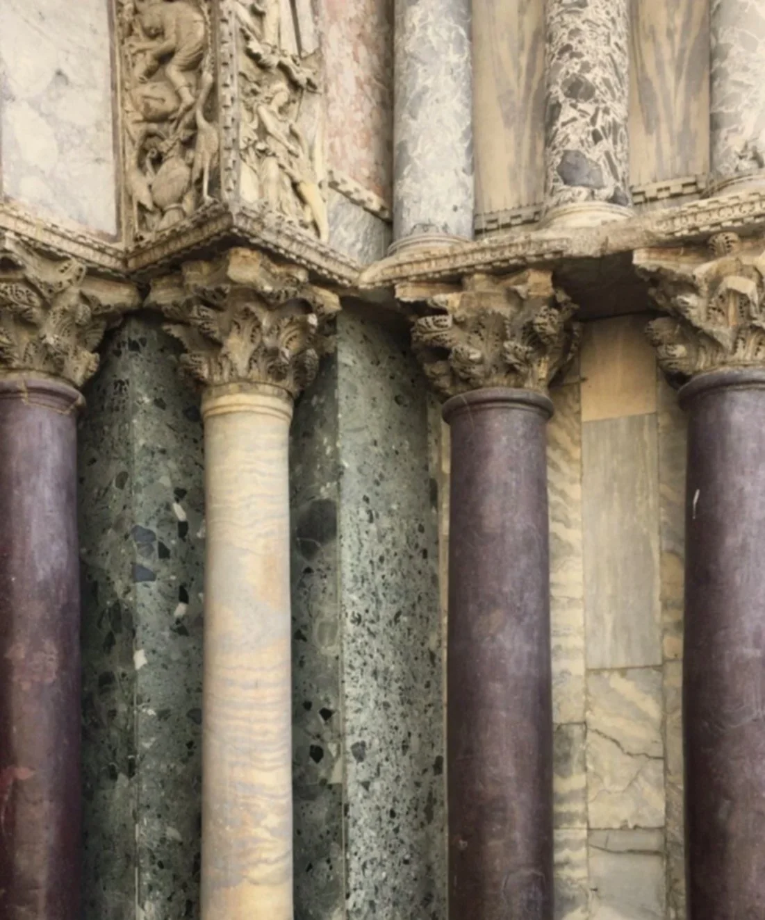 Close-up of ancient Corinthian columns and intricate carved capitals in a historical building.