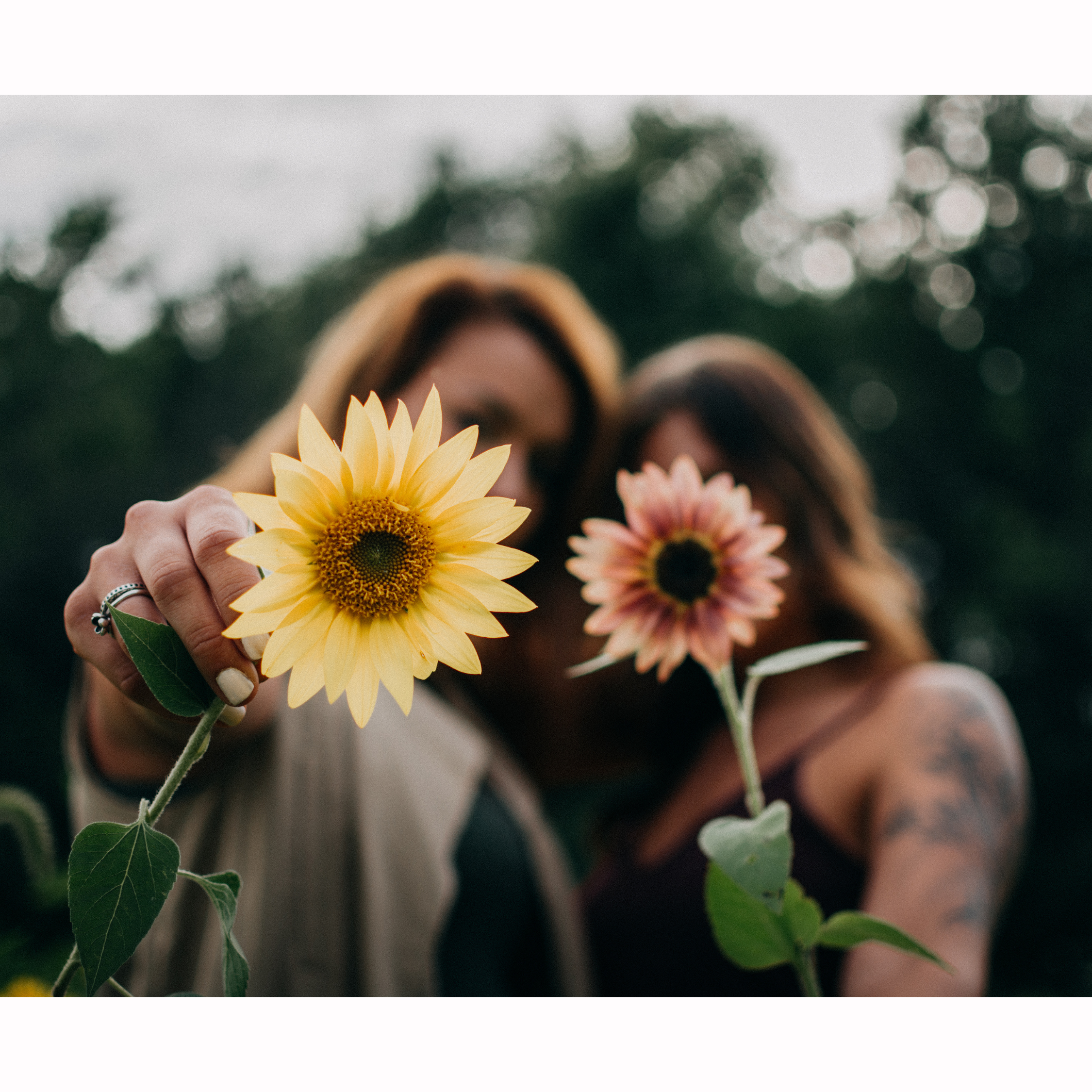Person holding flowers representing the hope and connection that is possible in the Congenital Heart Disease Community through Linked by Love