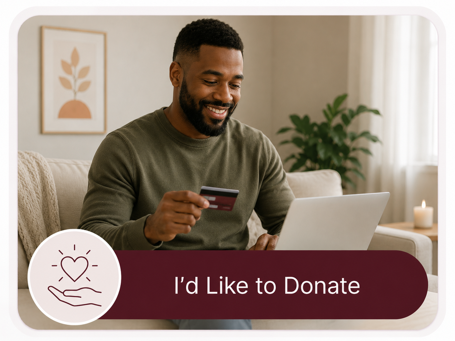 A smiling man sitting on a couch with a laptop in his lap, holding a credit card in his right hand, in a cozy living room with a plant and candle in the background. The image features a donation prompt with a heart and hand icon and the text "I'd Like to Donate".