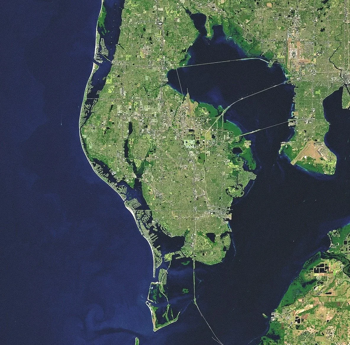 Satellite image of Long Island, New York, showing Manhattan, Brooklyn, Queens, Nassau, and Suffolk counties, with surrounding water bodies and bridges connecting the island to New York City and neighboring areas.