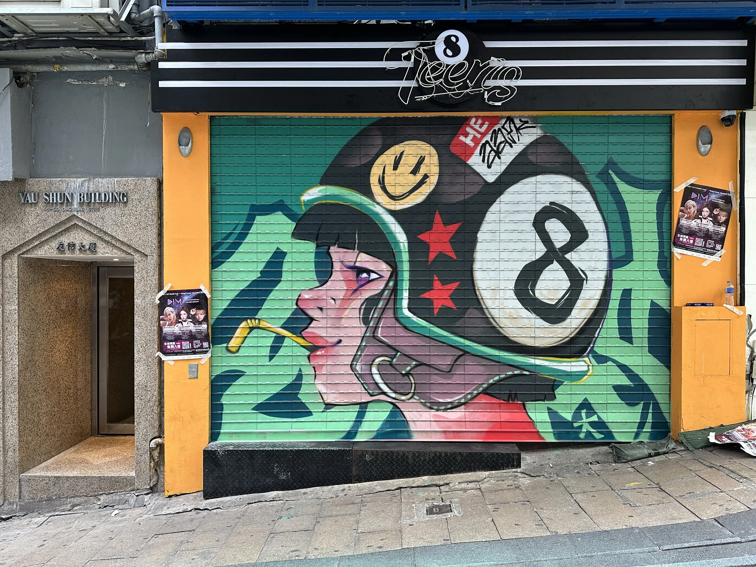 Art on the shutters of 8Teen bar in LKF by Macau-based duo AAFK 