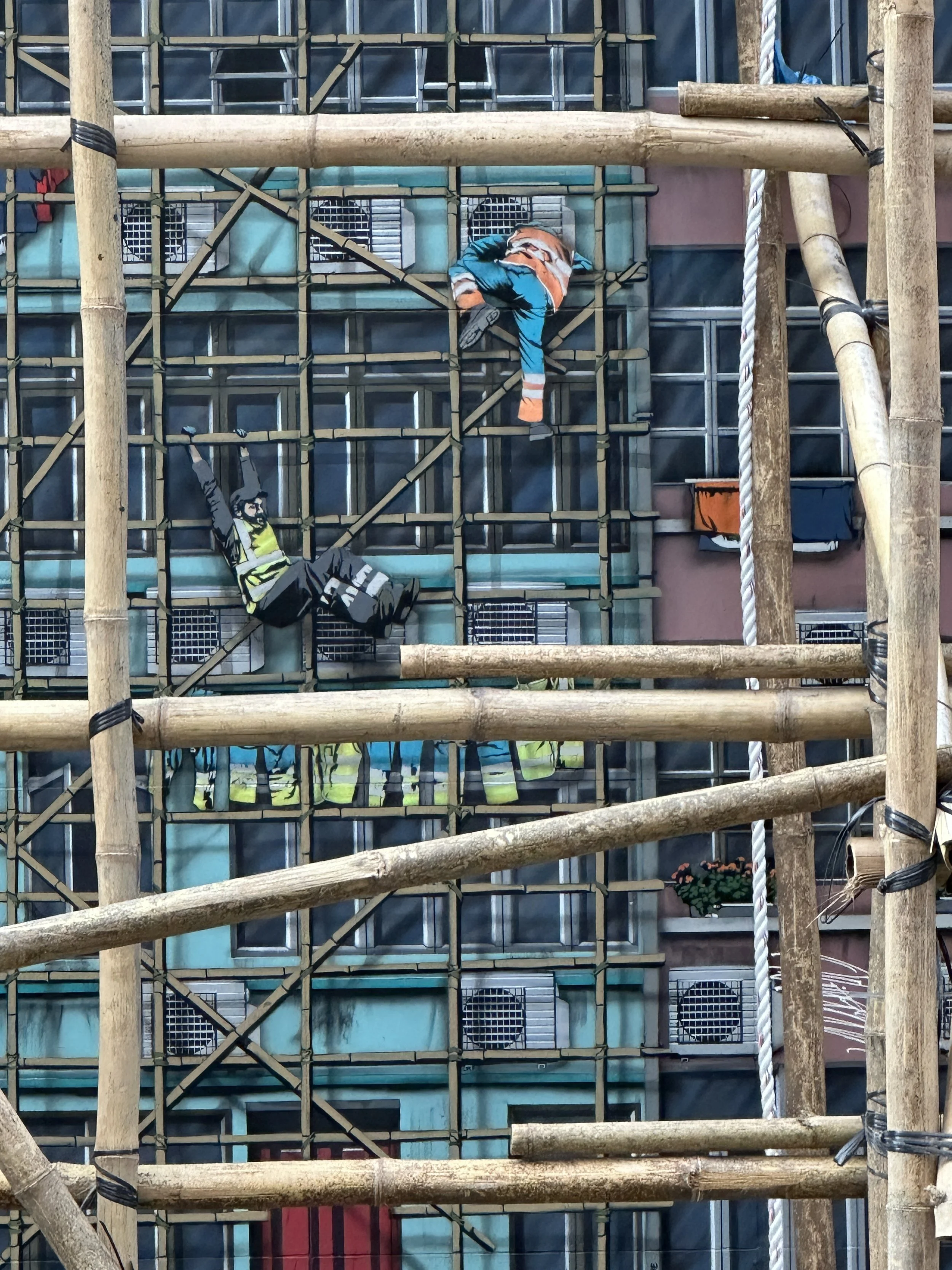Jaune's 'Mini Dudes' climbing a bamboo scaffolding