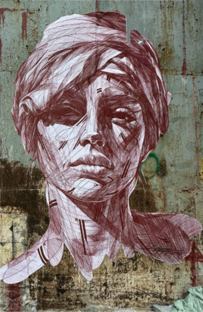 Street art mural of a woman's face on a weathered wall.