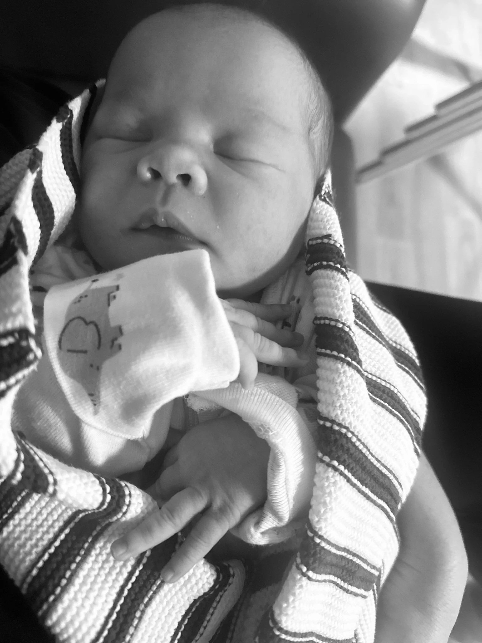 A newborn with a full tummy of colostrum sleeping off the birth