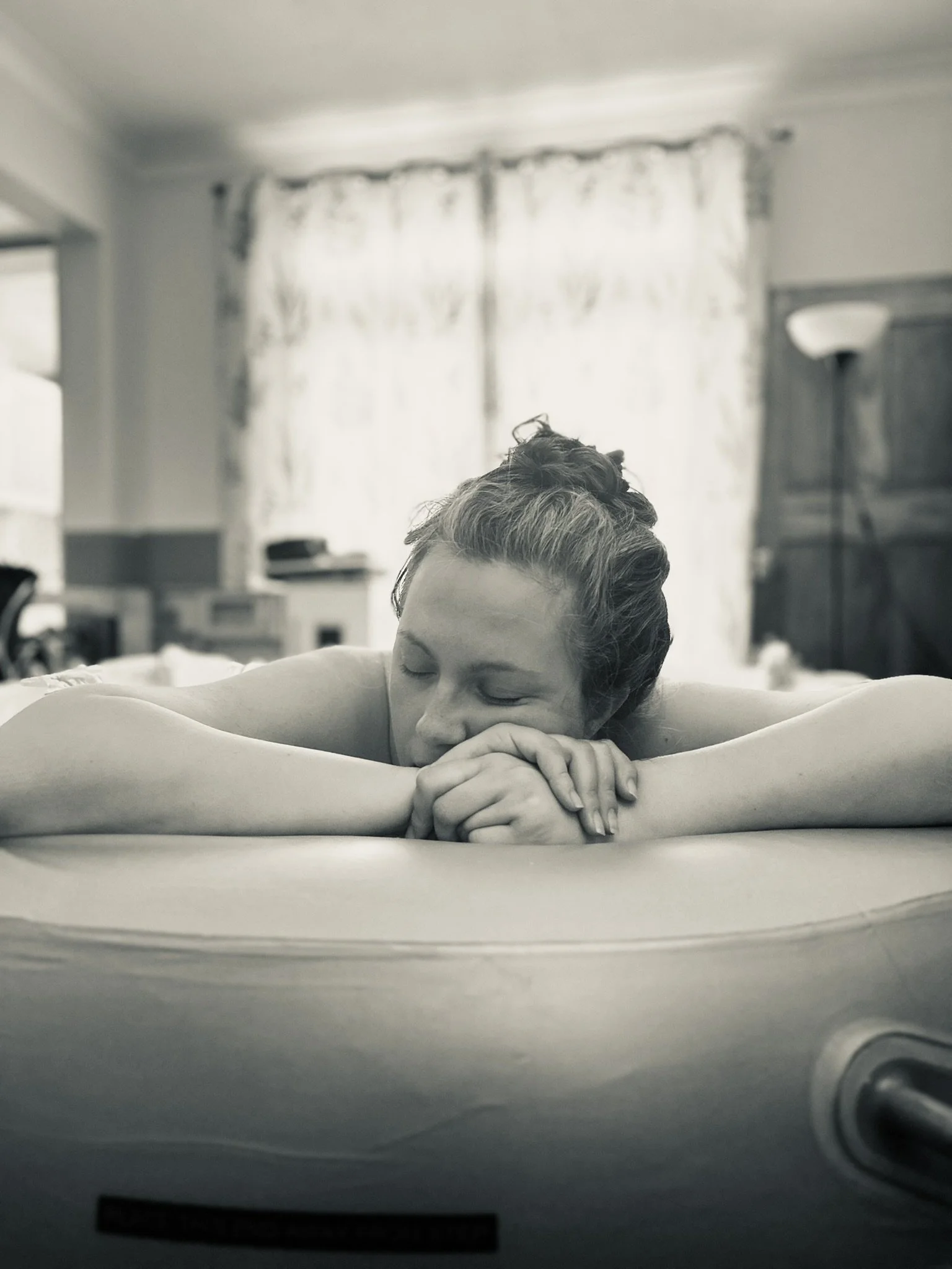 woman in birth pool at homebirth relaxing in labour