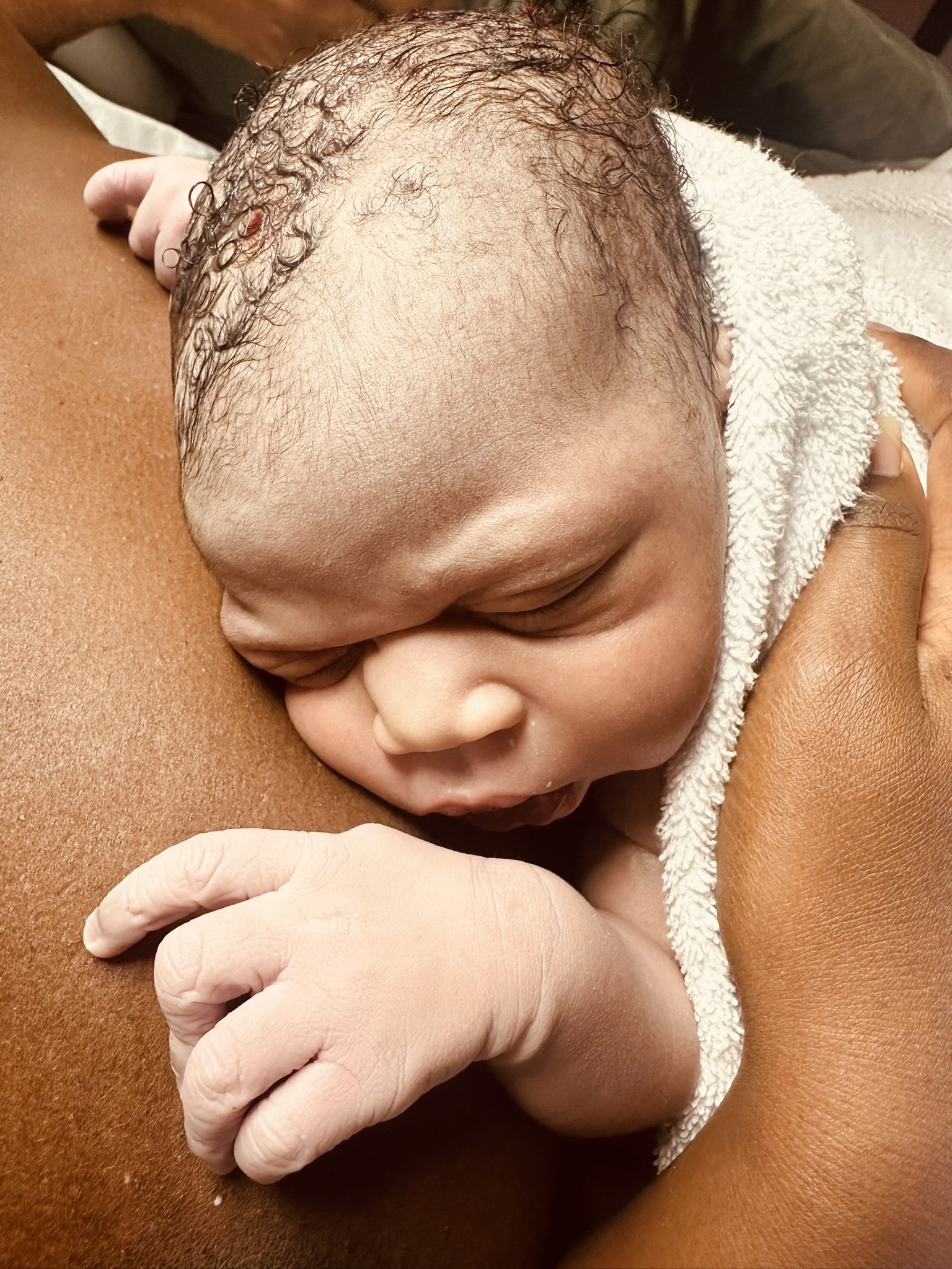 A newborn baby having skin to skin on mum's chest
