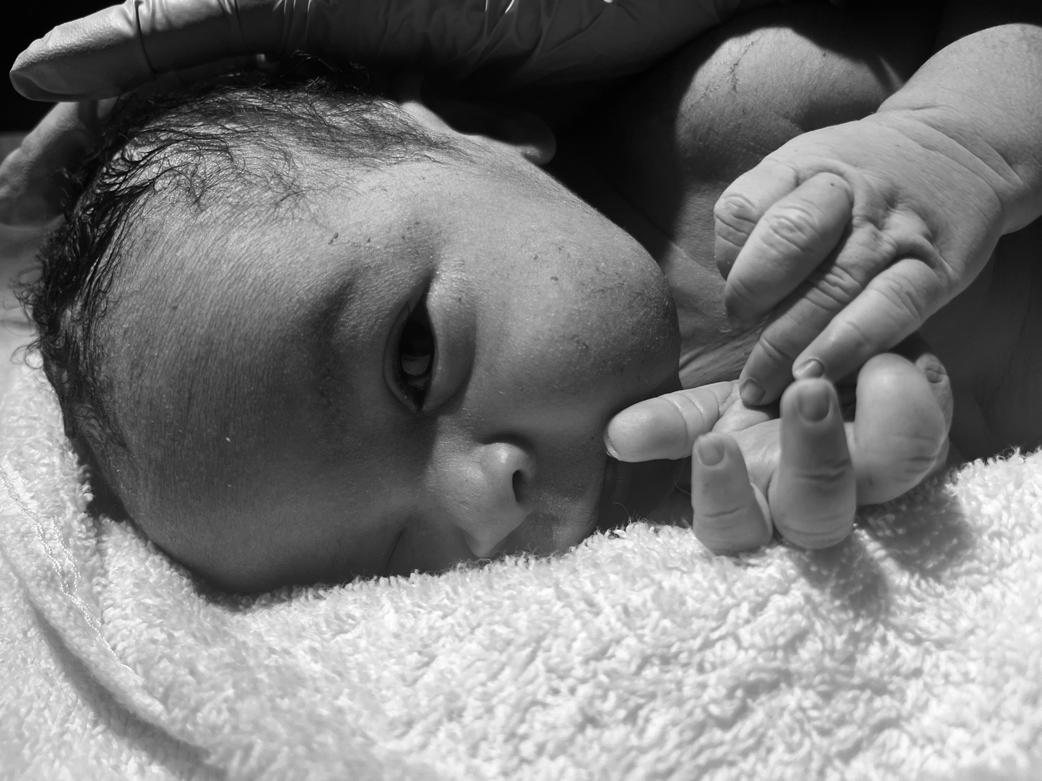 A newborn baby having his initial newborn checks after birth