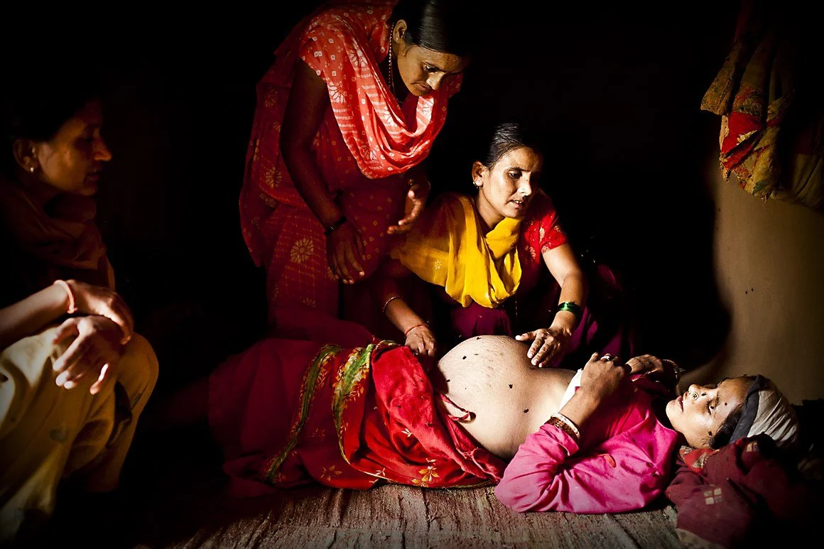 Woman in labour in Nepal being supported by Doulas
