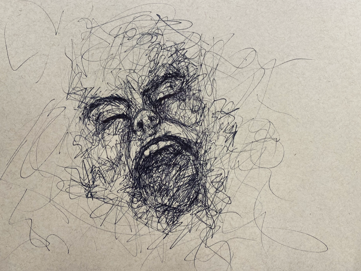 Scribbled sketch of a bear's face with an open mouth, surrounded by chaotic lines in black ink on paper.