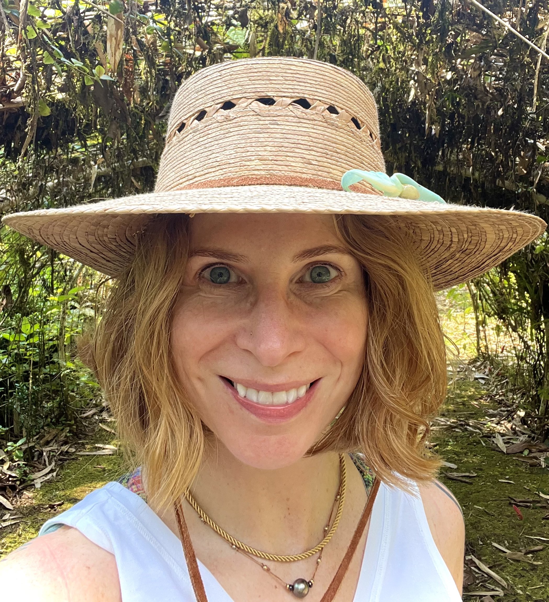 Kate Tredway outdoors in a straw hat