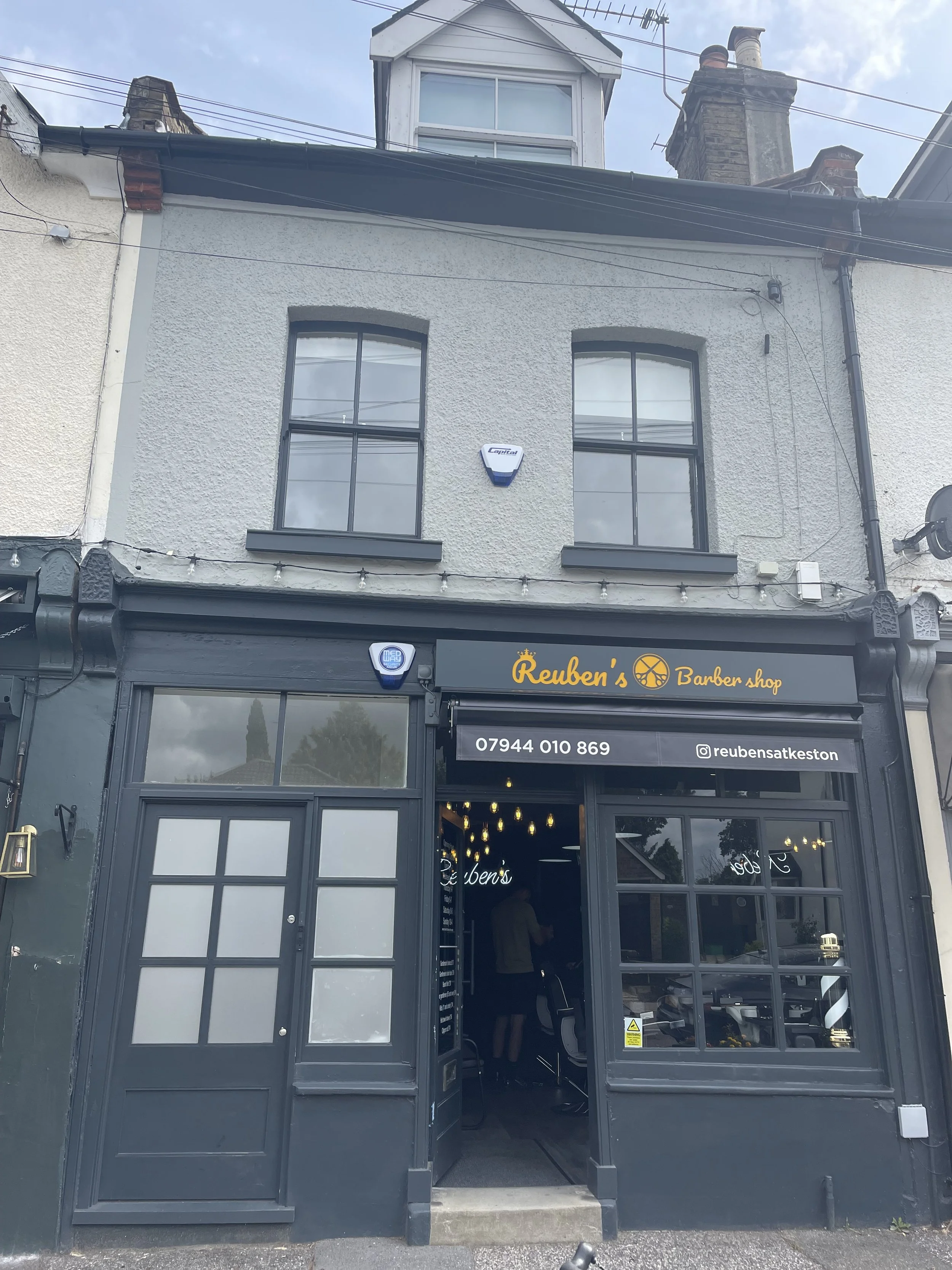 Exterior view of completed conversion into 2 flats and retail unit. Retaining existing shopfront where feasible and providing new entrance to upper flat. Bromley