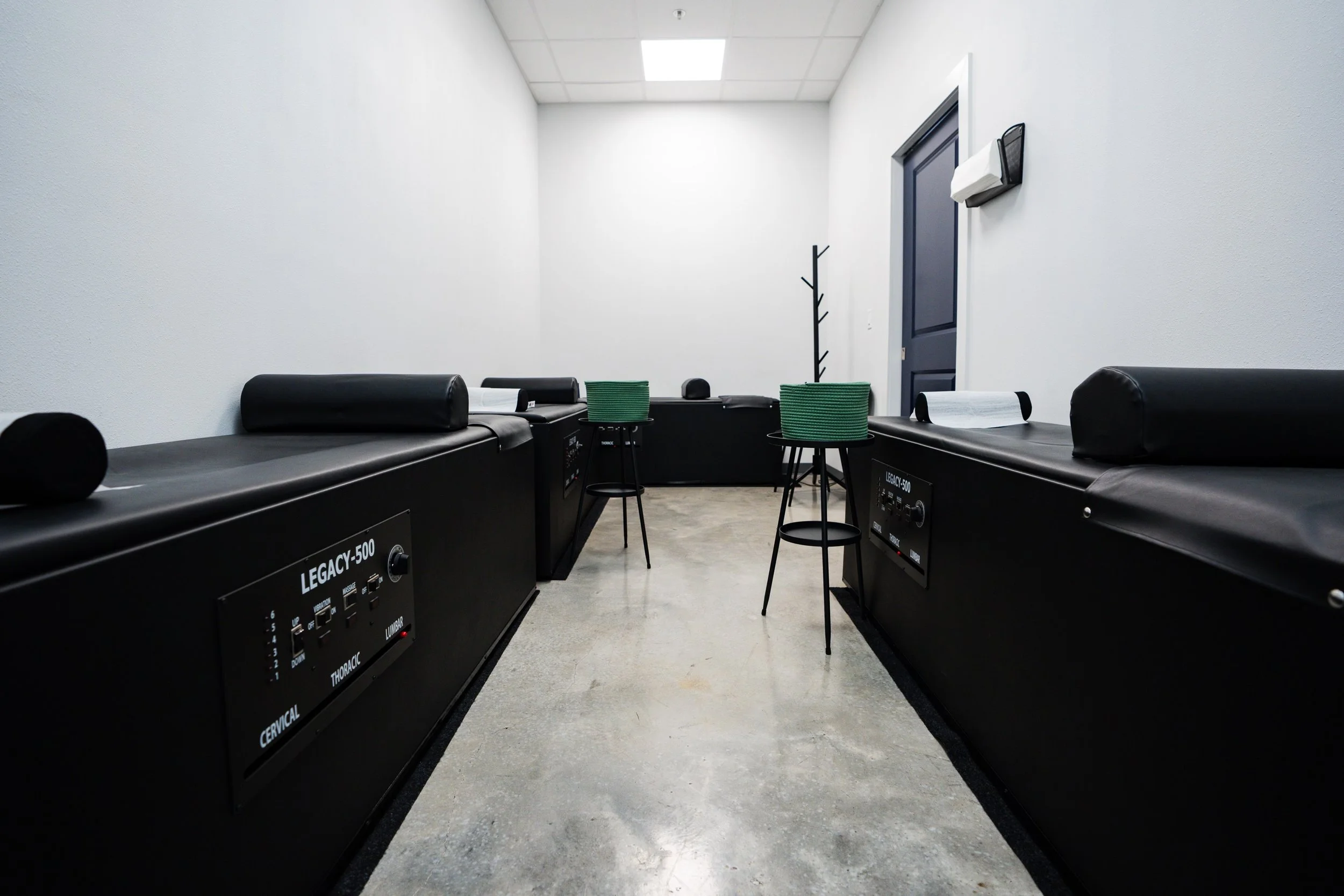 White outline drawing of an archery target with a bullseye and an arrow hitting the bullseye, set against a black background.