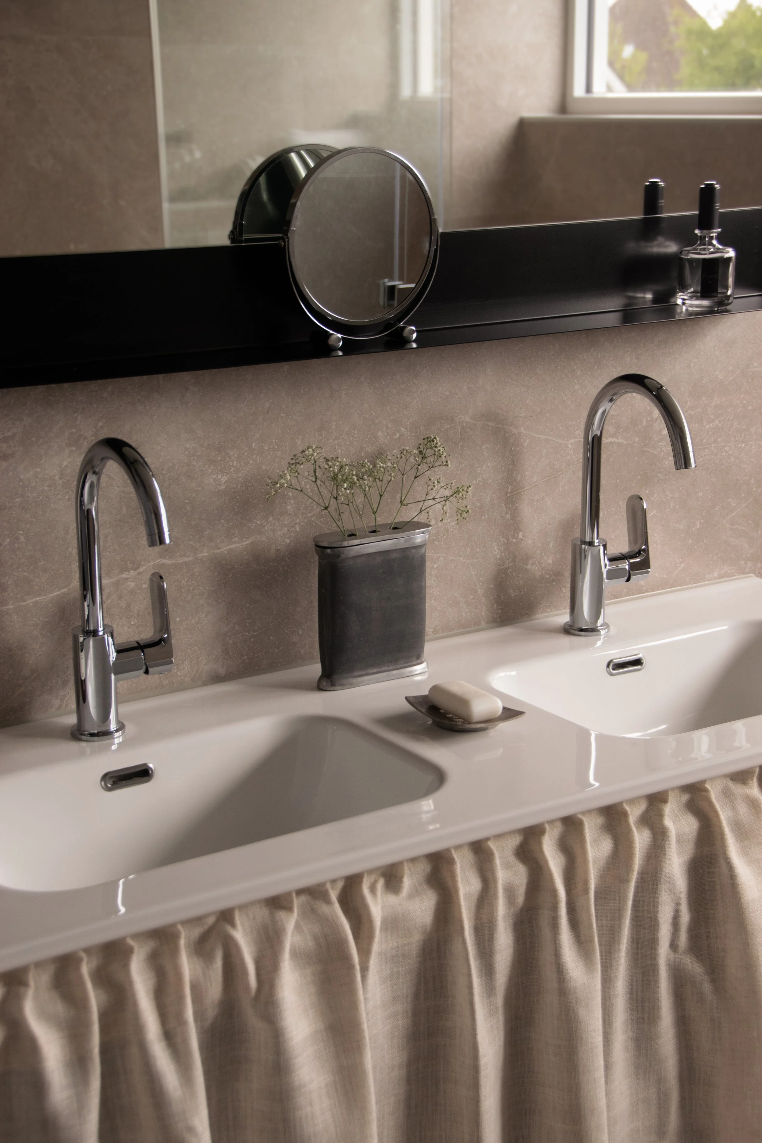 Double sink bathroom vanity with soft linen curtain detailing