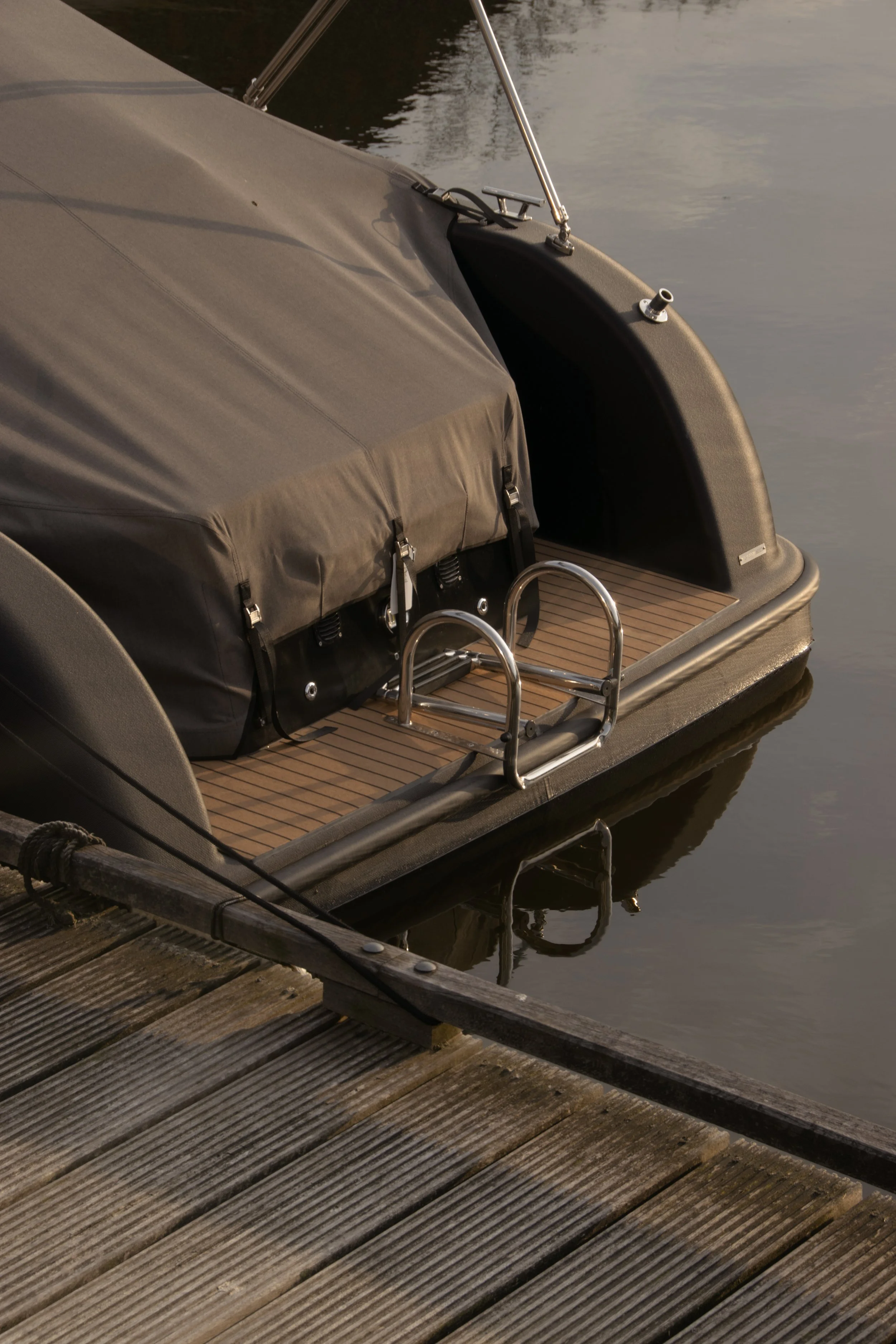 Outdoor detail of covered boat at waterside dock beside the country home
