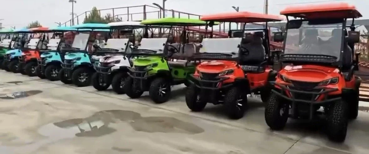 A row of colorful off-road utility vehicles parked on a wet pavement.