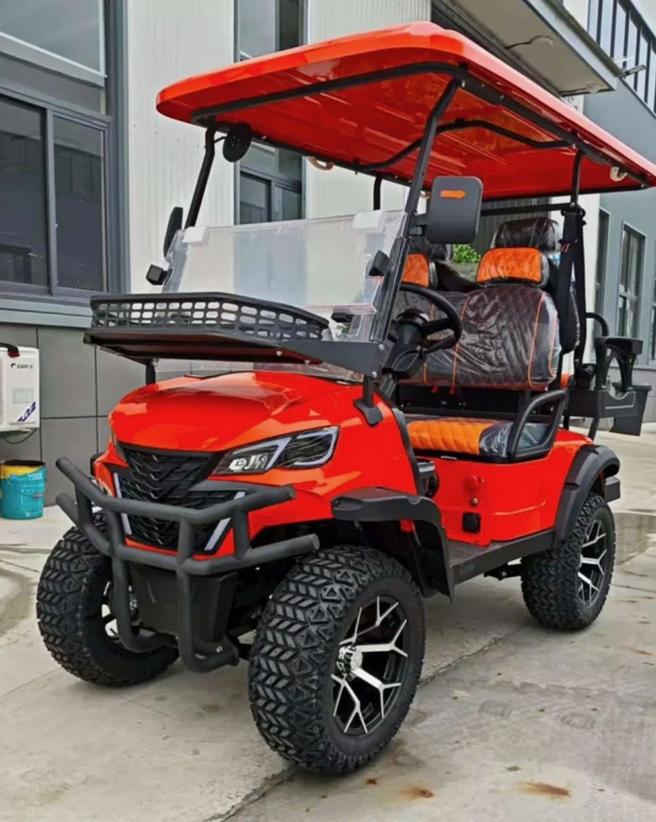 Red golf cart with large off-road tires, black front bumper, and orange and black seats, parked outside a building.