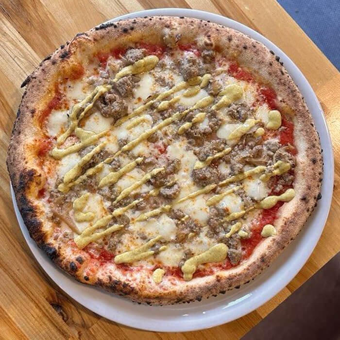 Special Oktoberfest pizza with bratwurst, sauerkraut, and mustard
