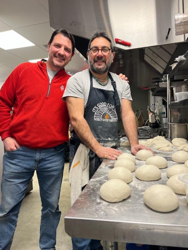 Chris and Alessandro standing in the pizzeria kitchen, preparing pizza dough balls