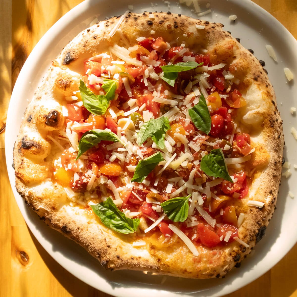 Bruschetta special pizza with tomatoes, basil, and pecorino cheese