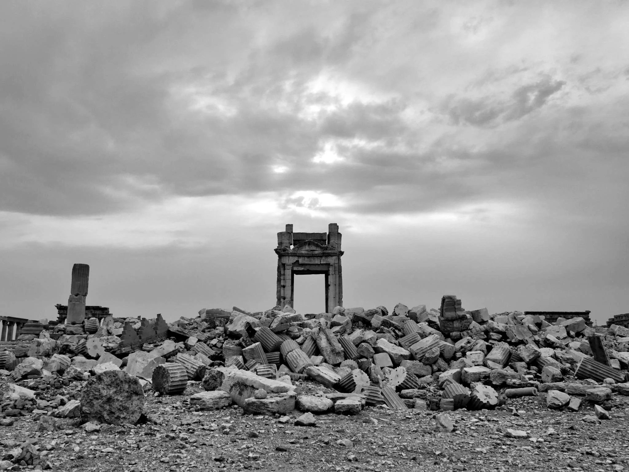 Temple of Bel, Palmyra, under cloudy sky.