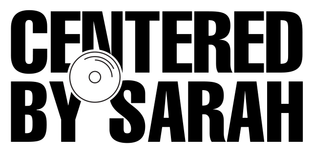 A black-and-white illustration of a compact disc (CD) with a minimalist design.