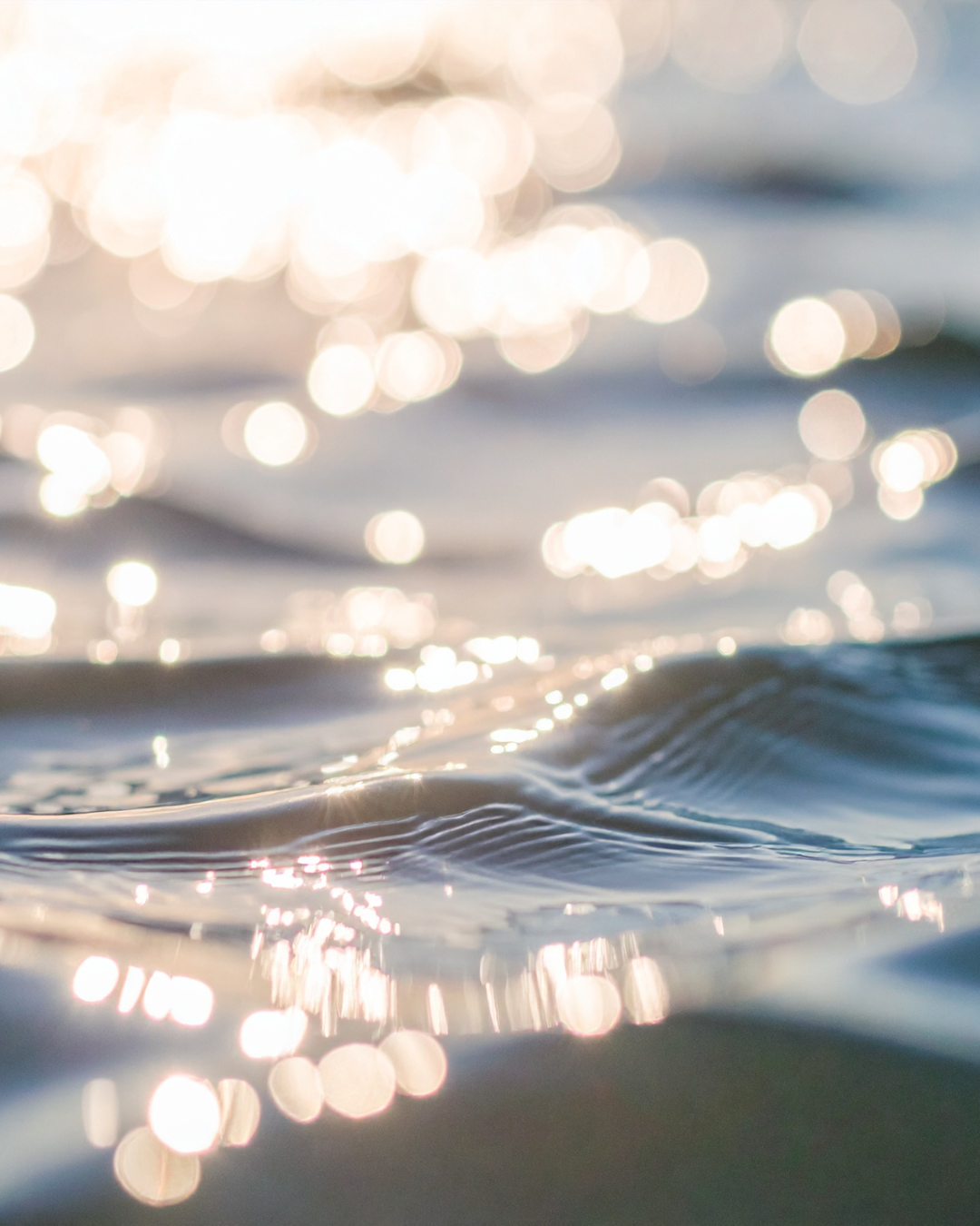 Close-up of water with sunlight reflections creating bokeh effect