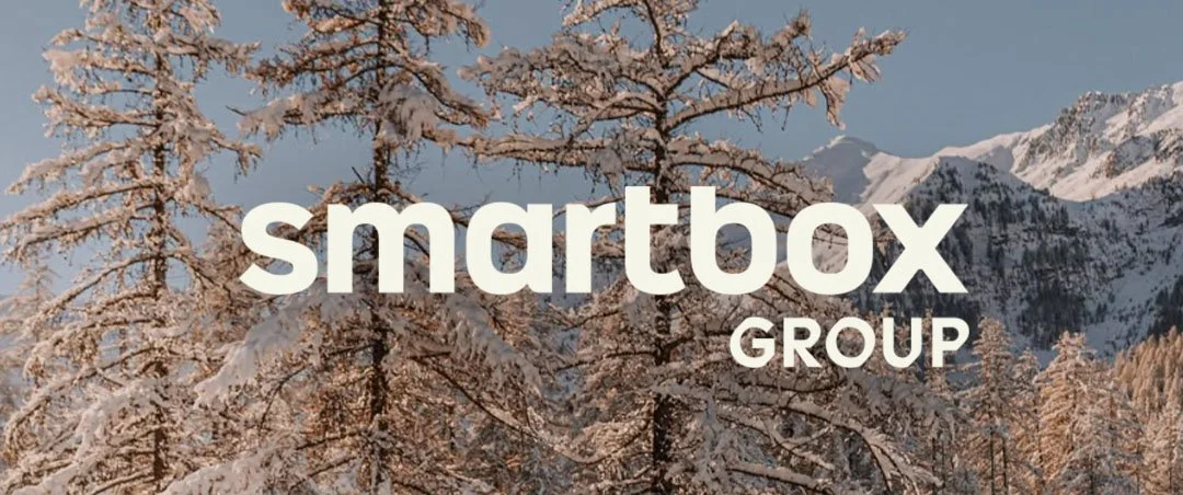 Snow-covered trees in a mountainous landscape with the text 'smartbox GROUP' overlayed.