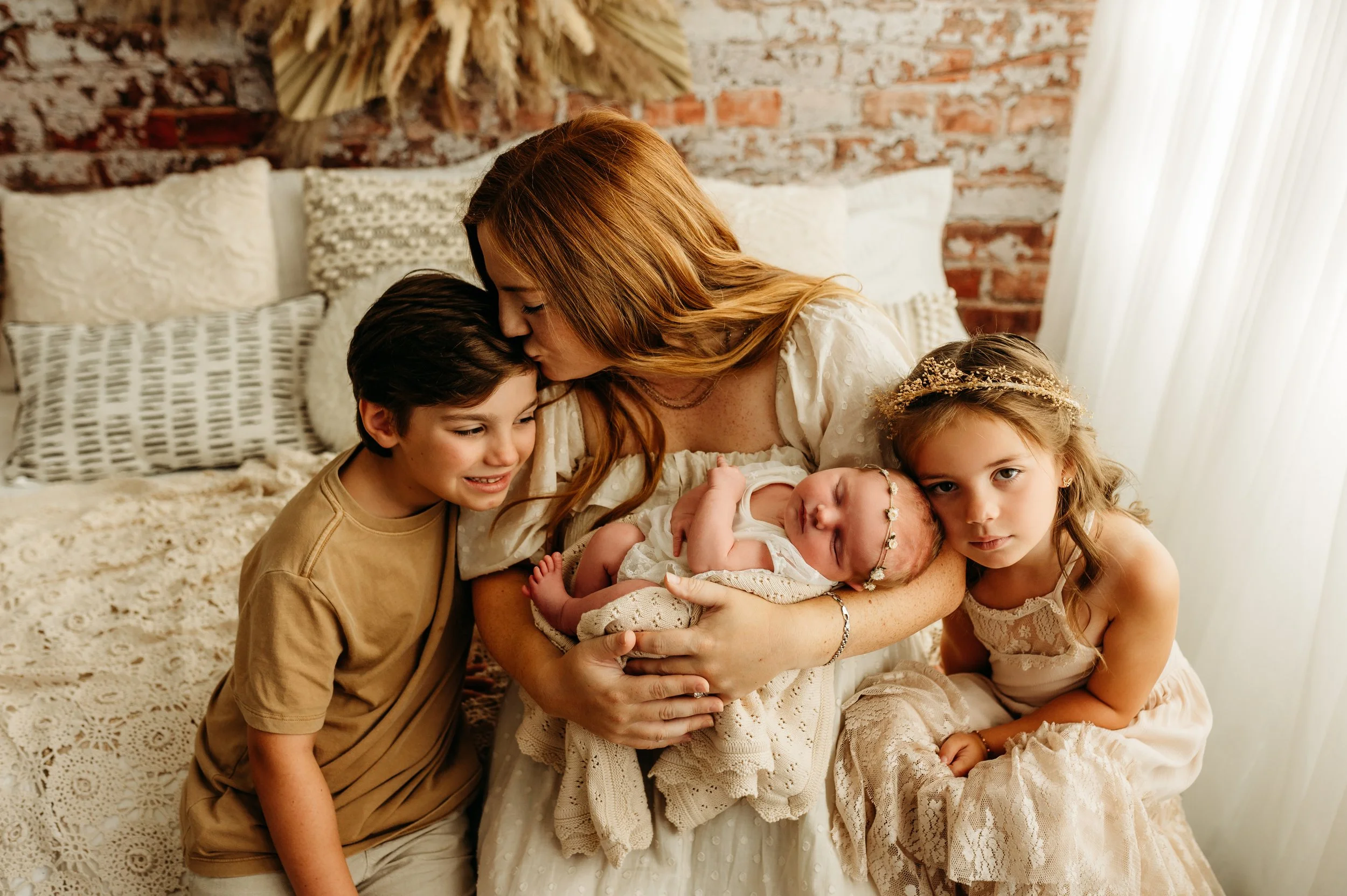 precious snuggles with mom, kids, and newborn baby girl in Clarksville, TN